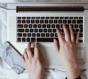 hands typing on laptop