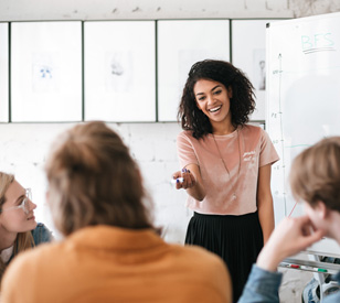 a female lecturer speaking to a group of people in a lecture