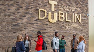 Students talking under the TUDublin sign at Grangegorman
