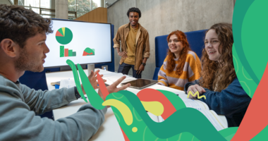 students sitting at a table with presentation