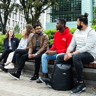students sitting on bench outdoors grangegorman