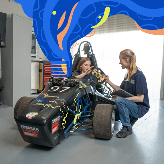 students working on race car