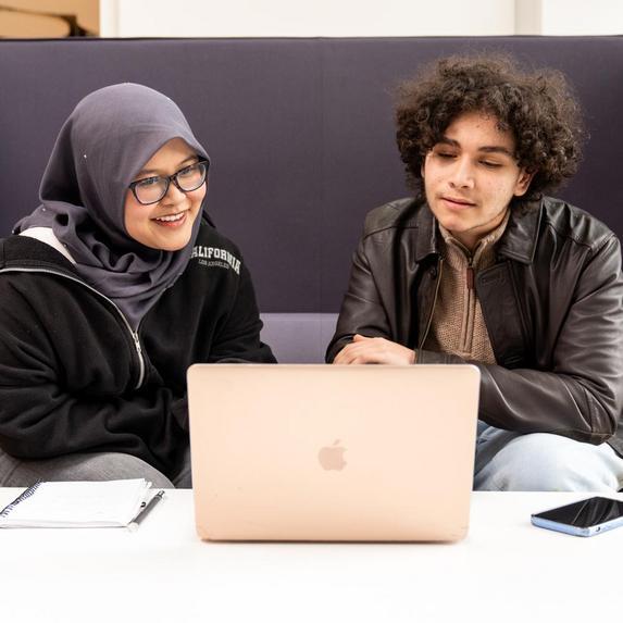 students sitting at laptop