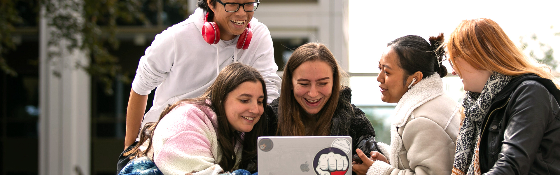 students laughing outdoors central quad
