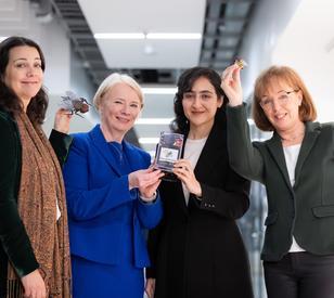 A group of people smile and pose