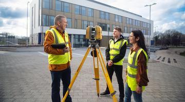 students surveying a new construction building