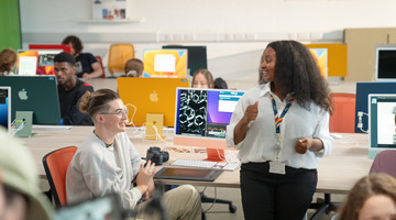 student discussion in computer lab with staff