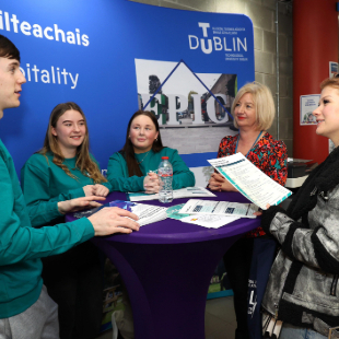 Students and staff talking around a table at TU Dublin Open Day.